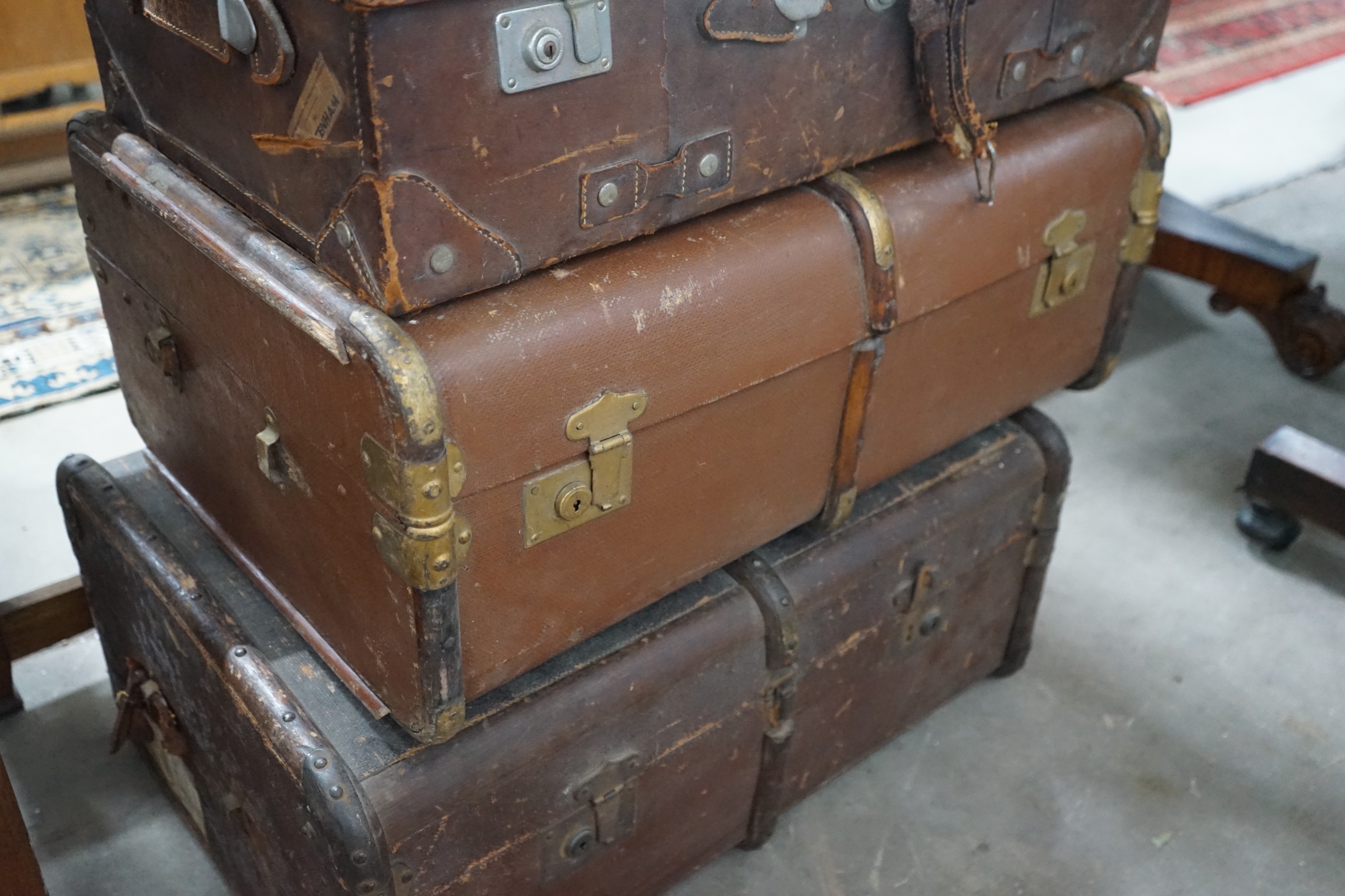 Three vintage suitcases, largest width 75cm